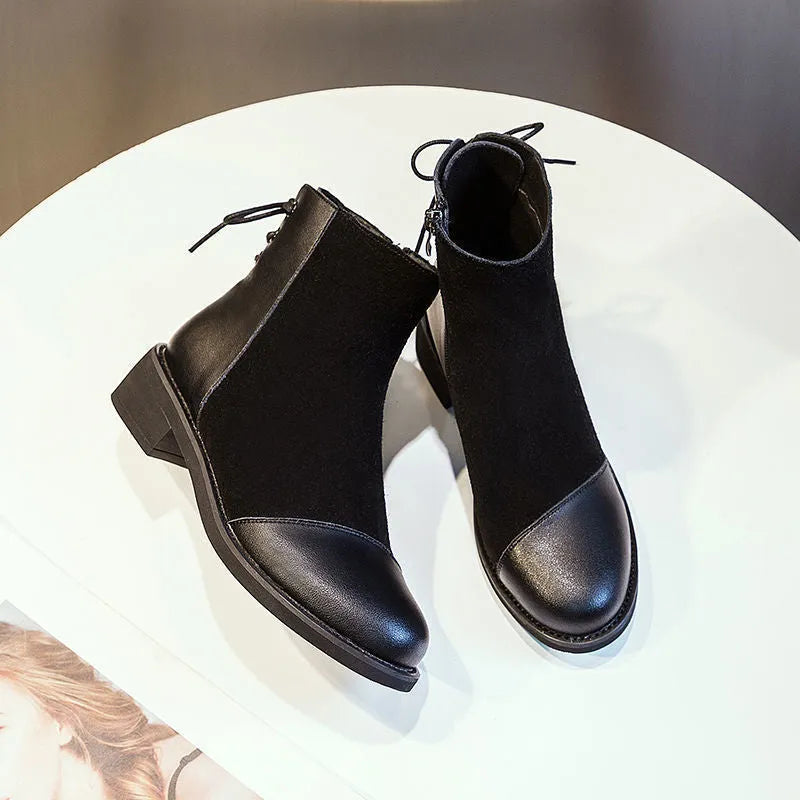 Black women's knee-high Martin boots with side zip and a decorative bow.