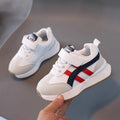 Children's white casual sneaker with Velcro strap, synthetic leather upper, and rubber sole on a neutral background.