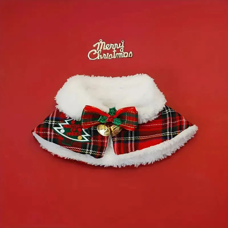 Red festive dog scarf with bell pattern fastened around a small dog's neck in winter.