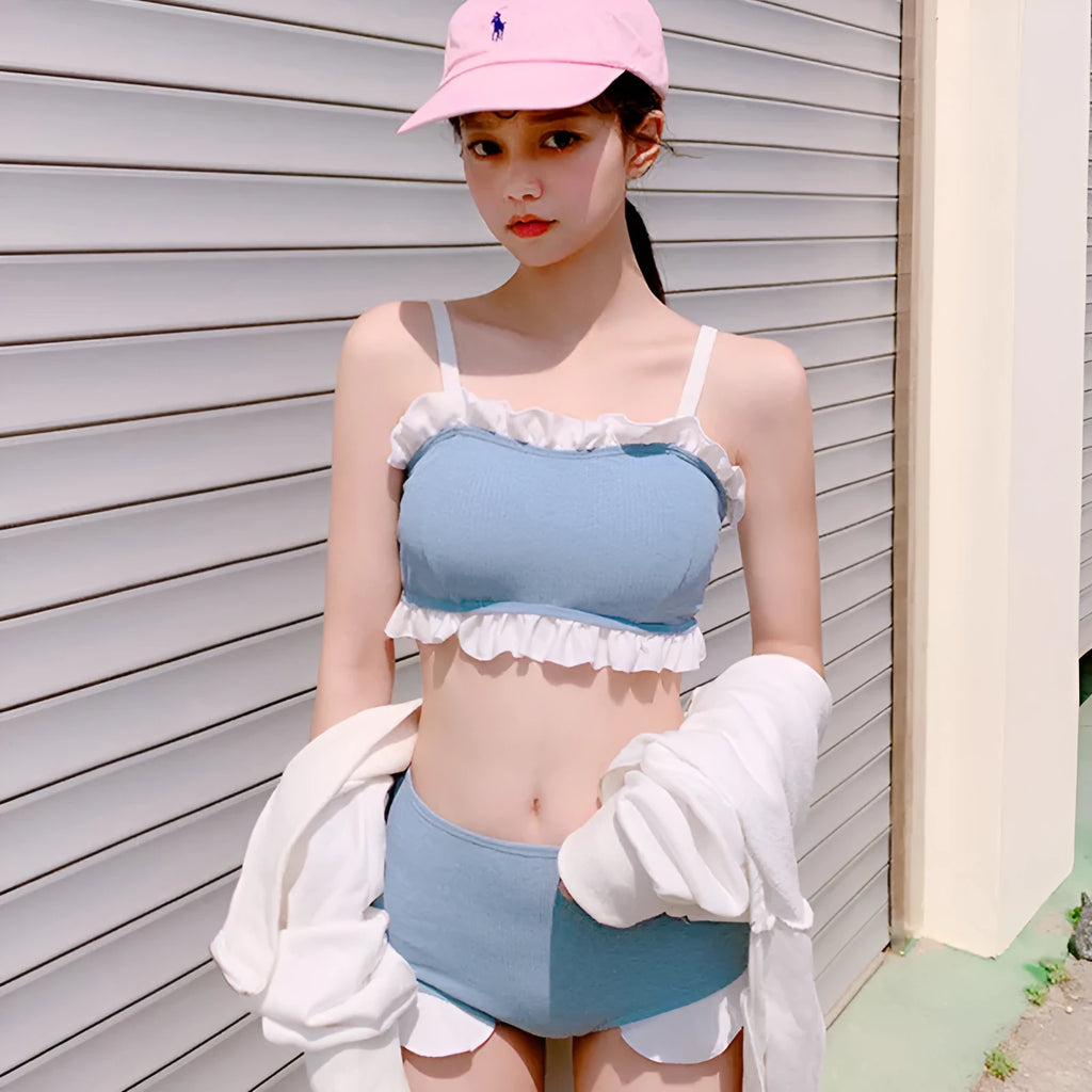 Women's solid colour one-piece swimsuit with fashion suspender straps, conservative cut for swimming.