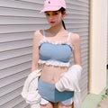 Women's solid colour one-piece swimsuit with fashion suspender straps, conservative cut for swimming.
