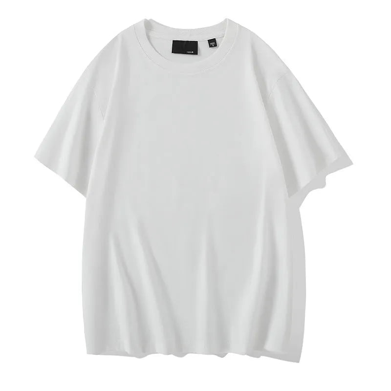 Man wearing a loose-fitting solid colour cotton t-shirt with drop-shoulder sleeves.