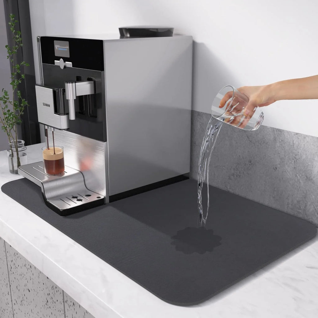Black square absorbent drain pad mat with PU leather surface on a kitchen countertop
