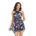 Women's one-piece swimsuit with a black tulle skirt and split-leg design on a mannequin.