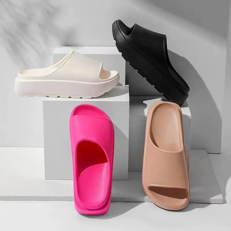 Women's beige fish mouth slippers with a thick EVA sole on a bathroom tile floor.
