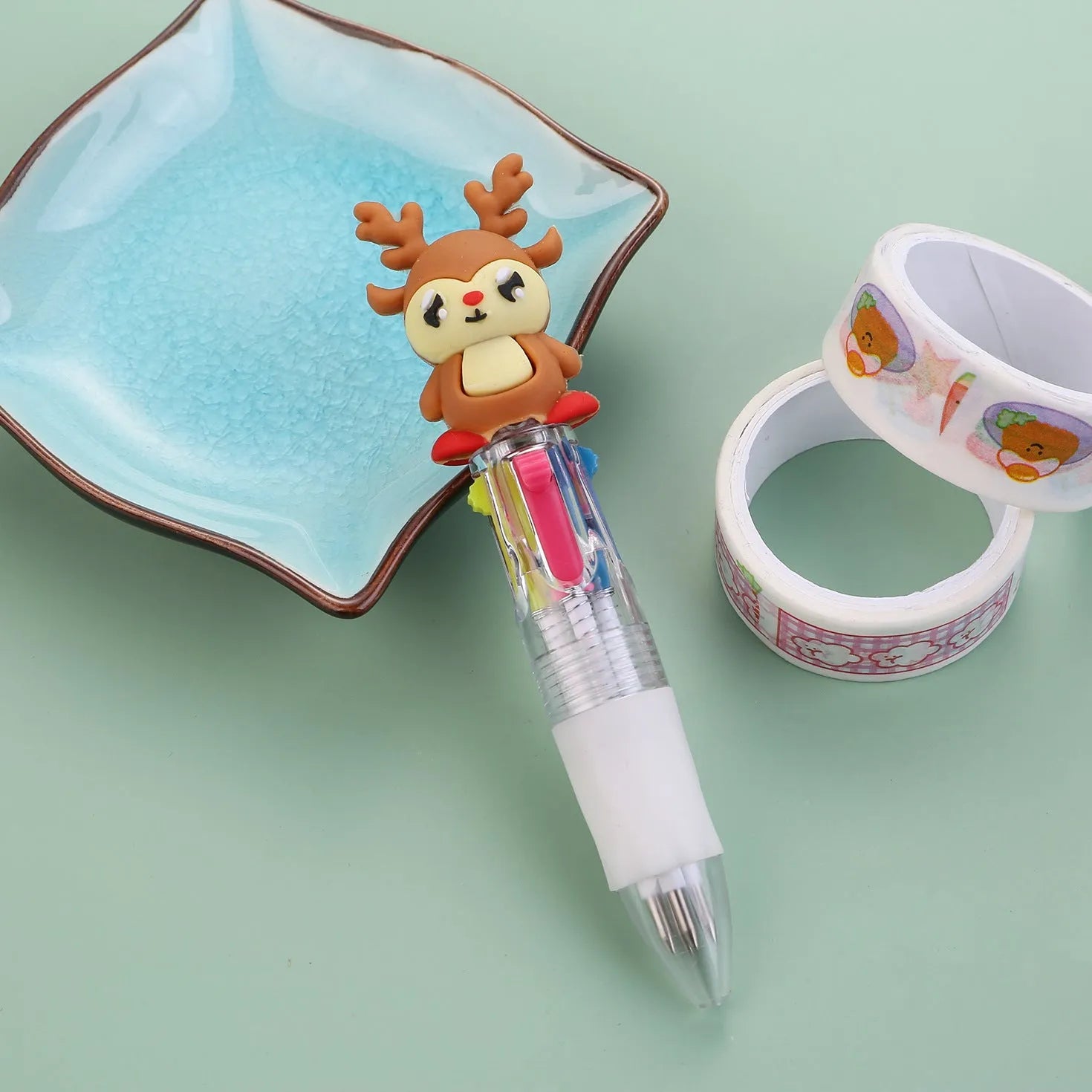 Compact 11cm Christmas ballpoint pen with four colours and festive designs like snowmen and reindeer.