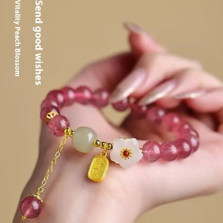Handmade strawberry quartz crystal bracelet for women showing green strawberry quartz moon design.