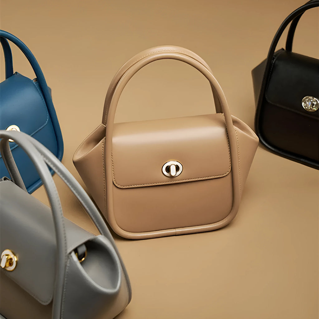 Women's leather wing tote bag in cow leather with buckle detail and cross-body strap