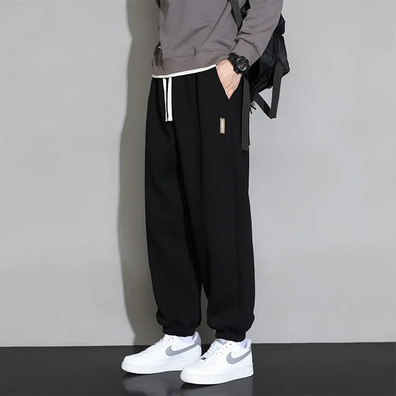 Men's loose fit grey sports trousers with drawstring waist and cotton-polyester blend fabric