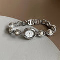 Women's quartz fashion bracelet watch with alloy case and pointer display, gold strap with white surface