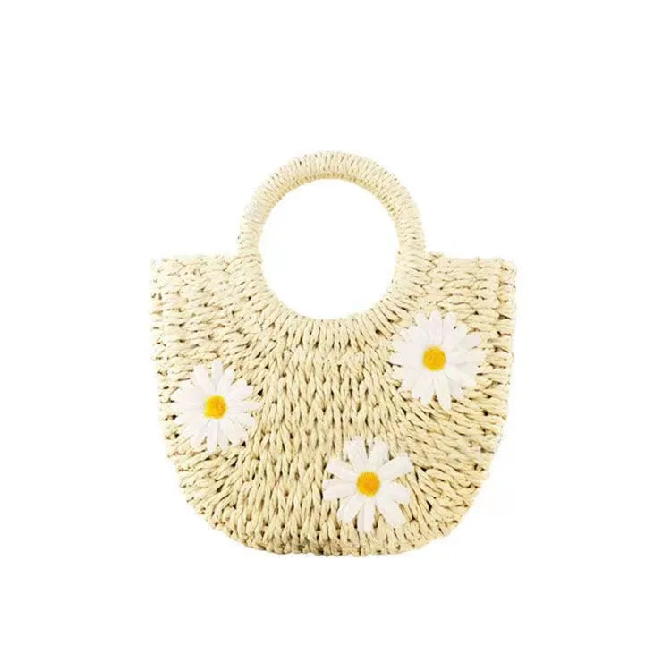 Light brown woven straw women's crossbody bag with a daisy pattern design.
