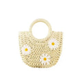 Light brown woven straw women's crossbody bag with a daisy pattern design.