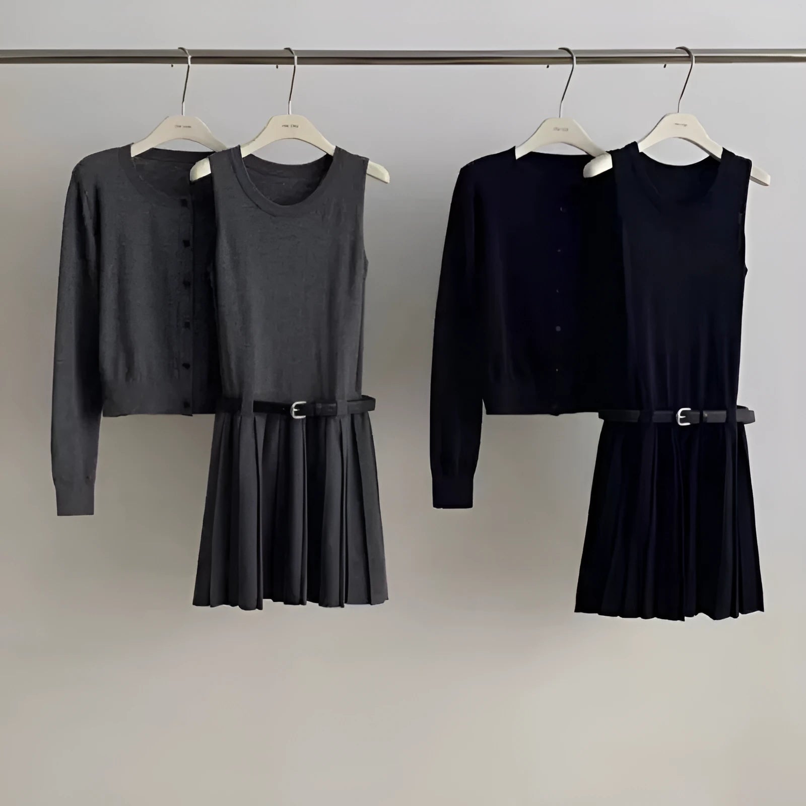 Women's grey Art Retro knitted set with 3D pattern, featuring a pleated midi skirt and long-sleeve cardigan.