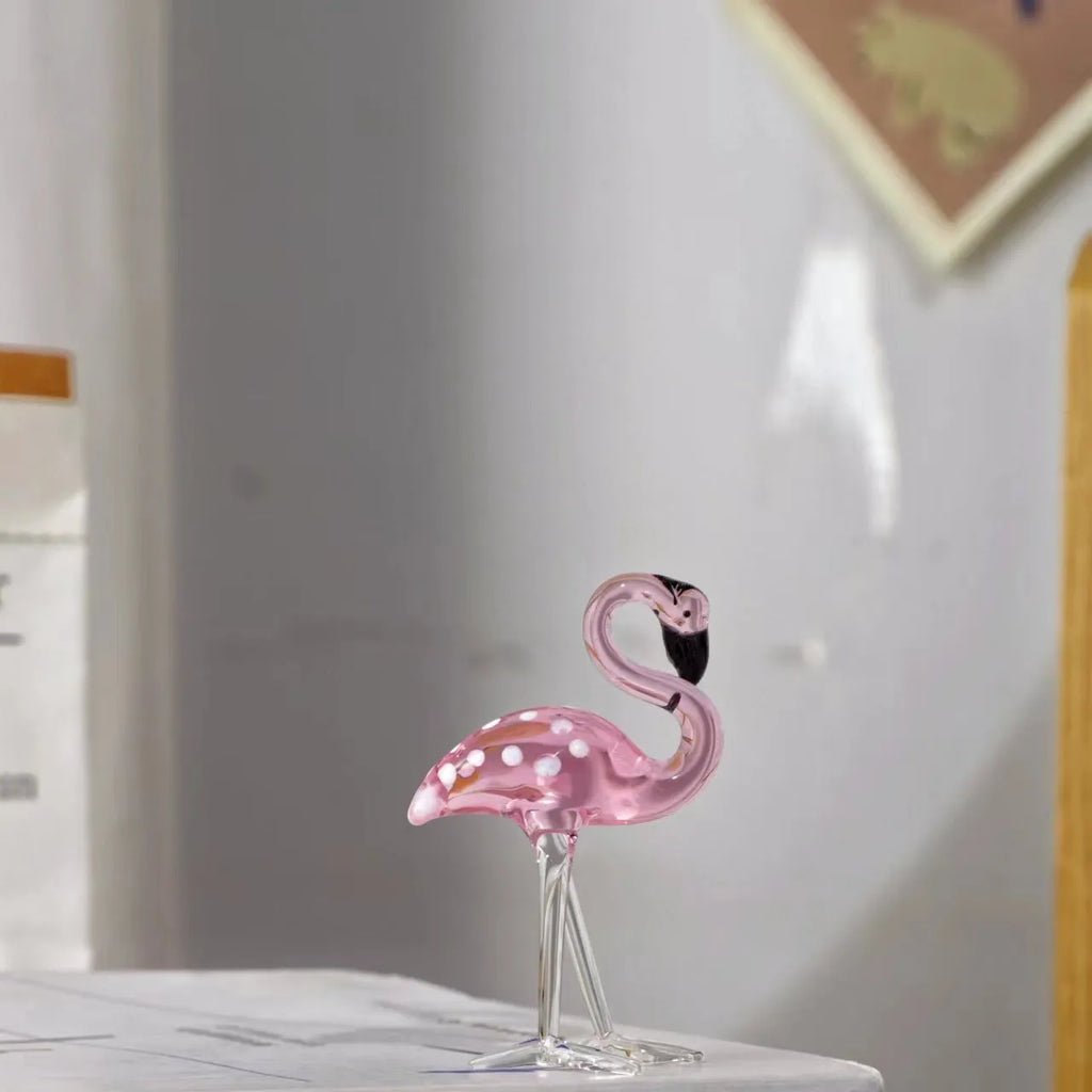Pink crystal flamingo decorative ornament on a table for modern home decor.