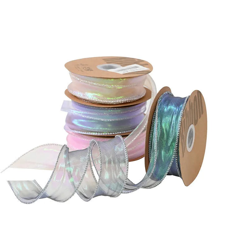 Roll of colourful fishtail yarn mesh ribbon showing its textured, wavy edge, with a colour selection including pink, yellow, and blue.
