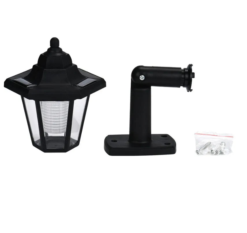 Black hexagonal solar wall light with solar panel for outdoor garden installation