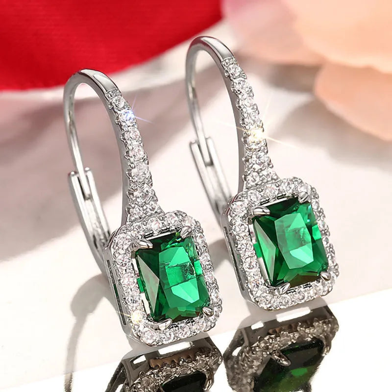 Pair of white gold colour copper earrings with inlaid zircon stones in geometric ring and quadrilateral design