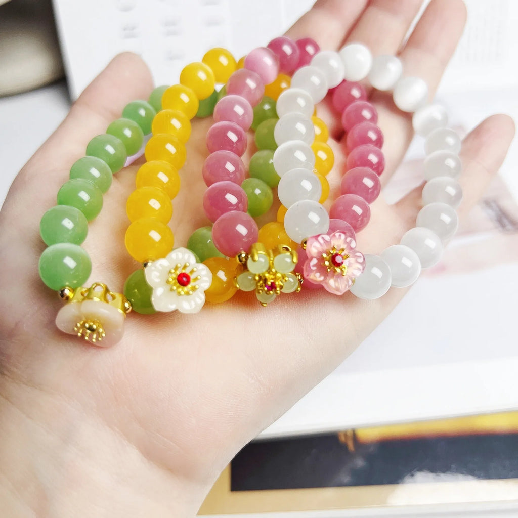 Women's handmade glass beaded bracelet with floral design in yellow, pink, white, or green colours