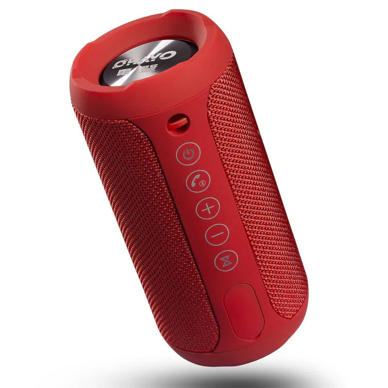 Compact waterproof Bluetooth speaker in camouflage colour, shown outdoors on a rock.