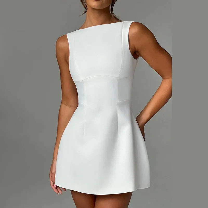 A woman wearing a slim-fitting black backless sleeveless dress with a high waist and short skirt.