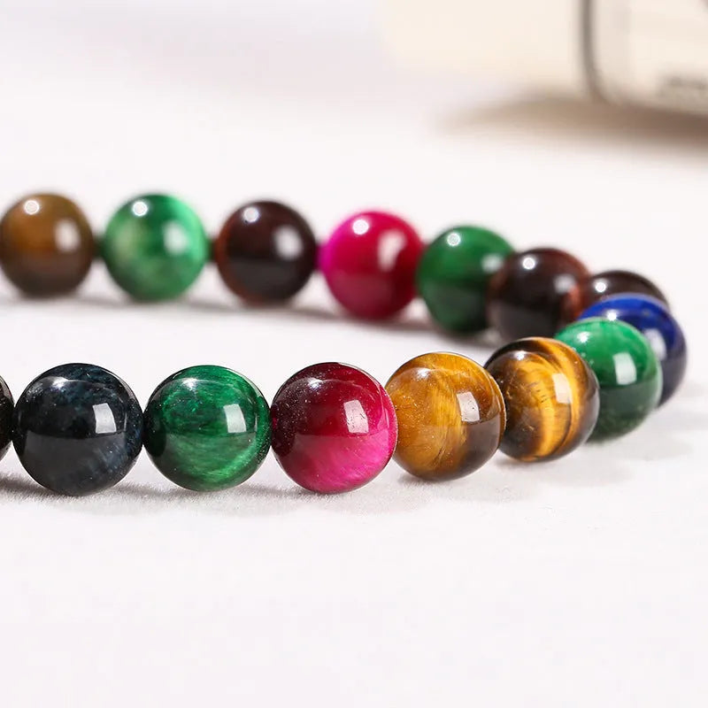 Colourful Tigereye natural stone bracelet with geometric round beads in multiple sizes on wrist