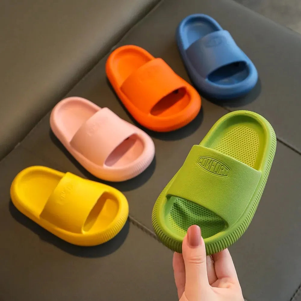 Children's mixed colour EVA slippers with textured non-slip soles and 1.5cm thick cushioning.