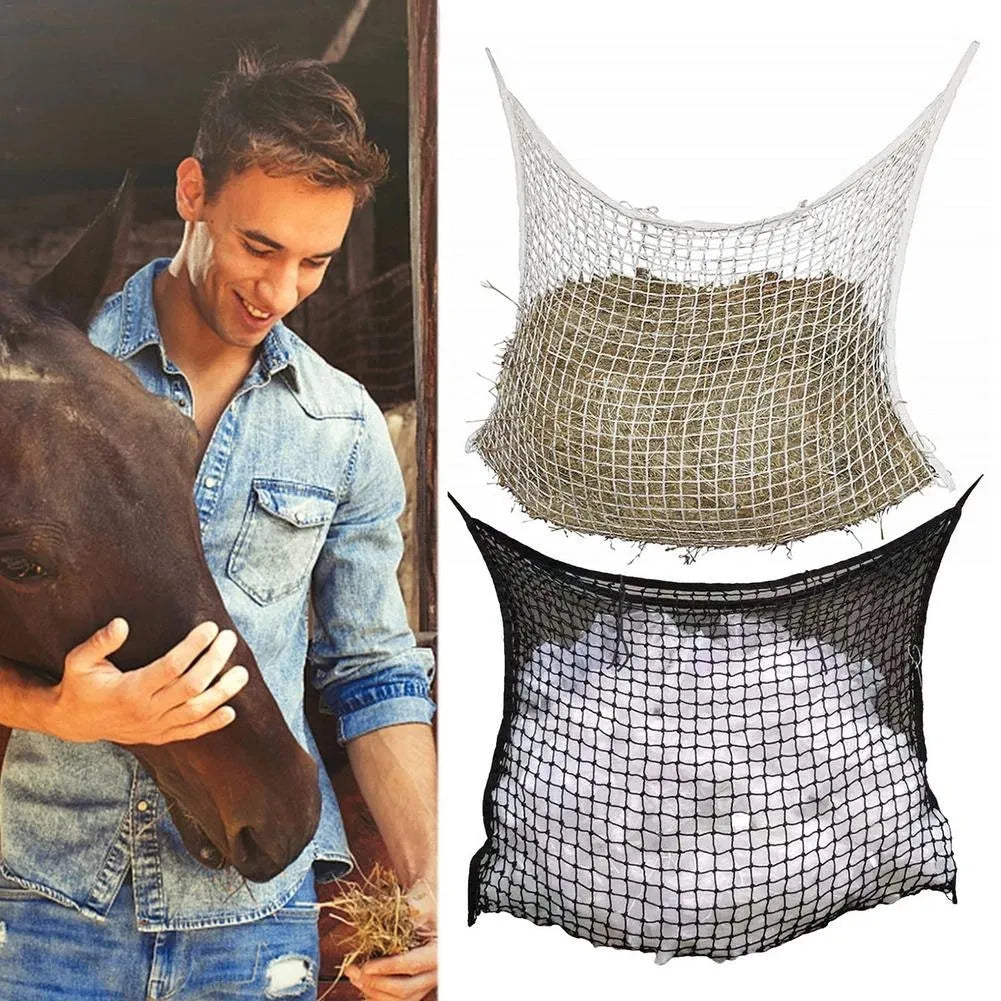Woven polyethylene rope horse feeding bag in black hanging with hay visible through grid