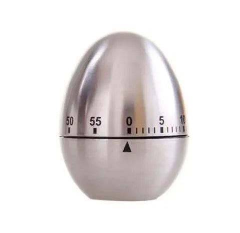 Stainless steel egg-shaped mechanical kitchen timer on a kitchen countertop