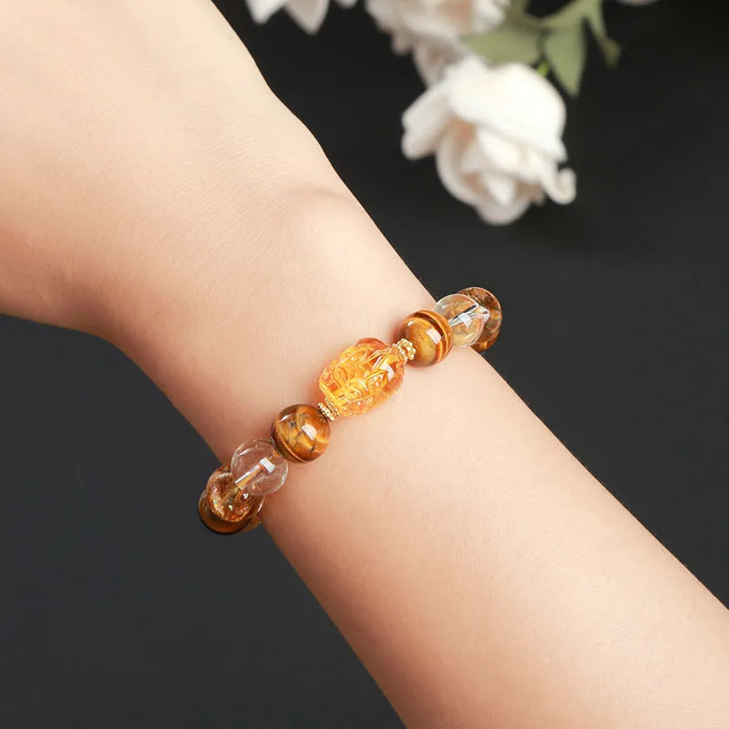 5A natural yellow tiger's eye and citrine bracelet with 10mm geometric beads and a beeswax pi xiu charm.