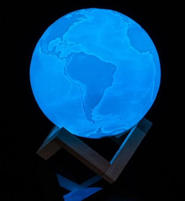 3D printed moon lamp on wooden stand showing detailed lunar surface, with touch ring at base.
