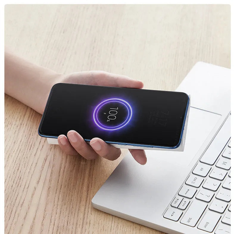 Black and white 10000mAh power bank with fast charging and wireless output features.