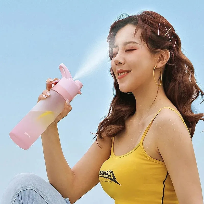 White 700ml plastic spray water bottle with handle strap and leakproof lid.