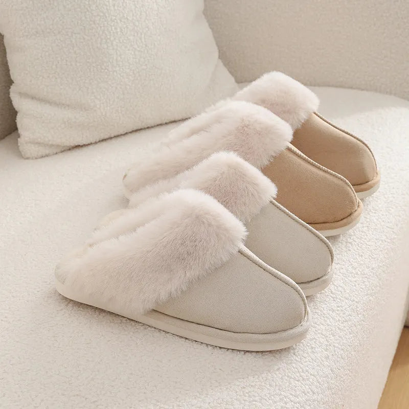 Women's brown plush indoor slippers with a round toe, flat heel, and stitching detail.