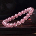 Polished strawberry quartz crystal bracelet for women, shown in three bead size options: 6mm, 8mm, and 10mm.