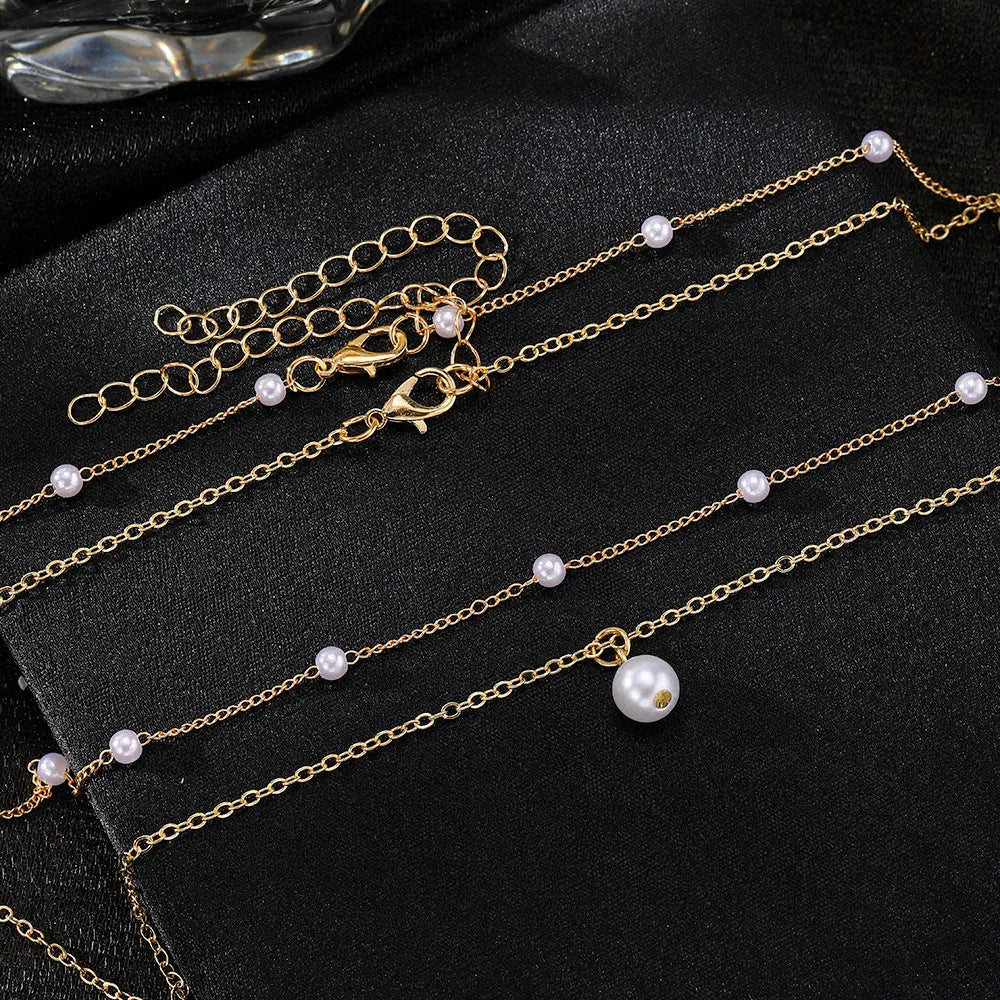 Women's gold pearl tassel pendant double-layer necklace set with alloy O-ring chain on display showing three colour variants
