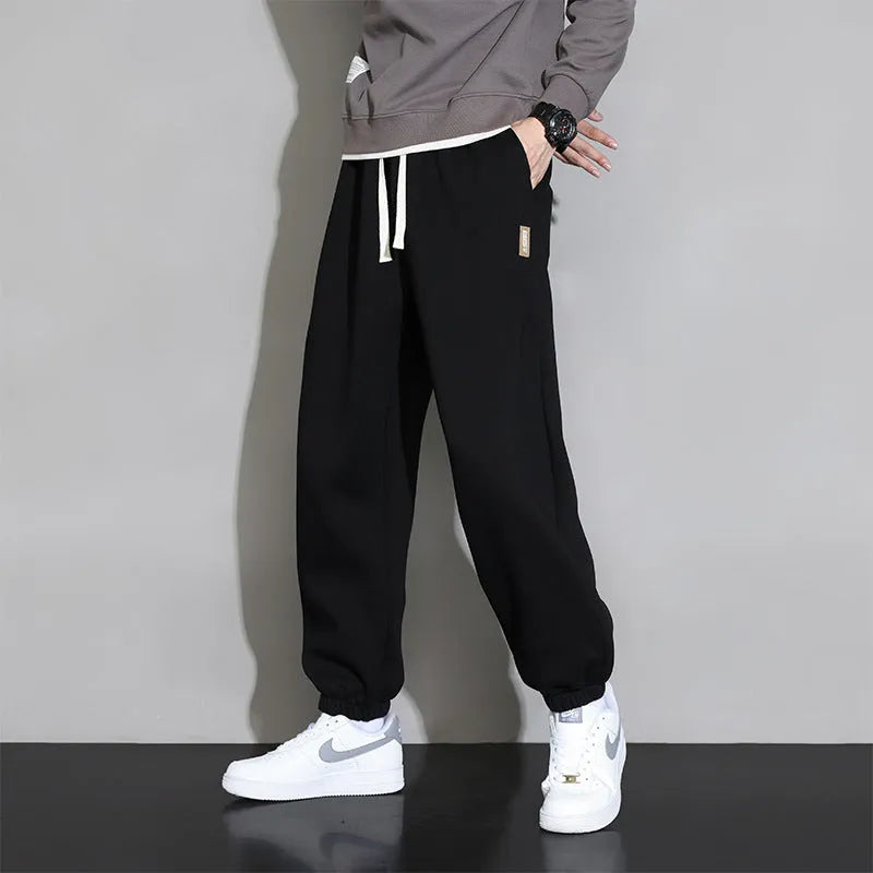 Men's loose fit grey sports trousers with drawstring waist and cotton-polyester blend fabric