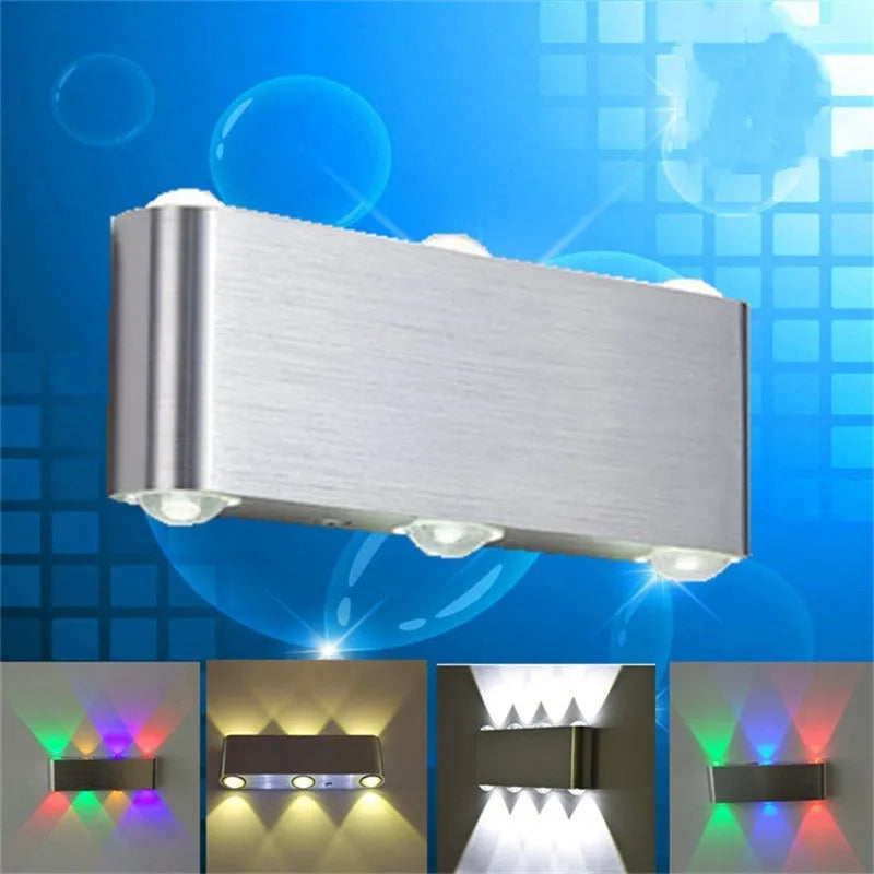 Silver aluminium rectangular LED wall lamp showing seven light colour options including blue, green, and warm white