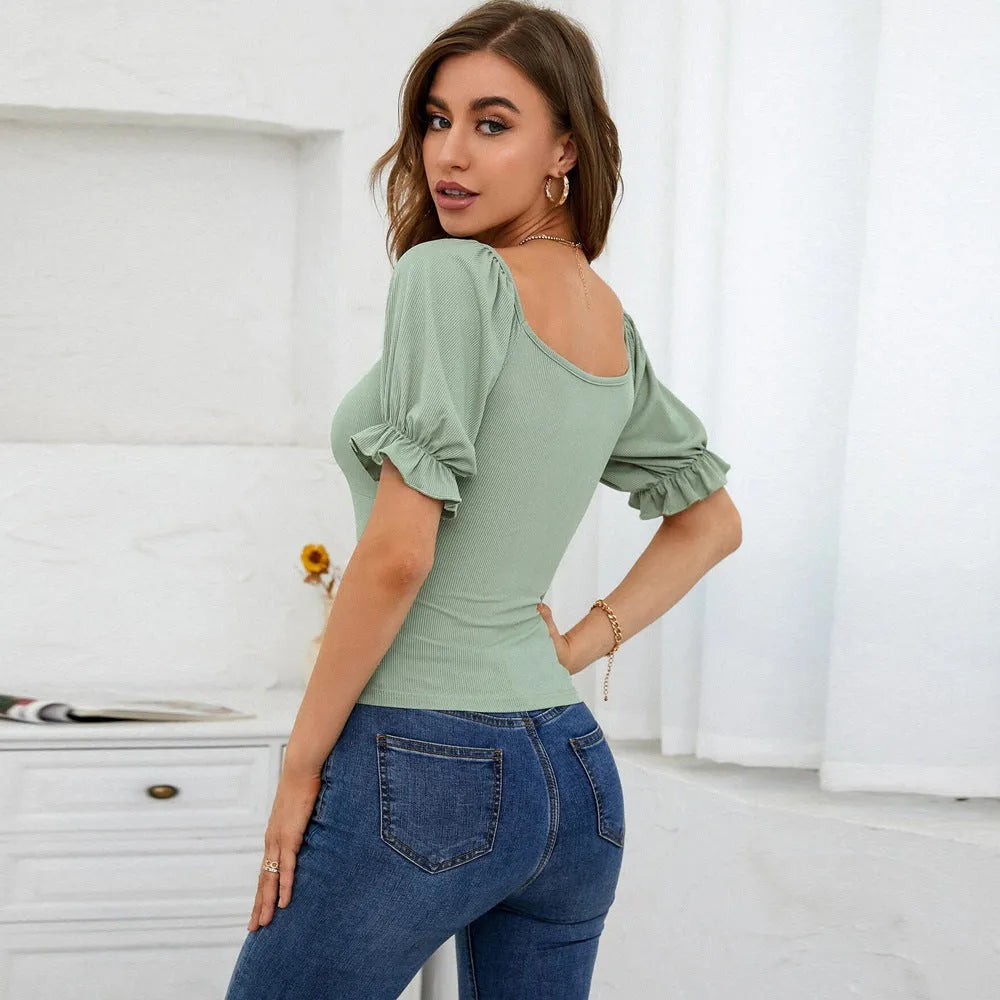 Women's slim-fit light green knit top with puff sleeves and waist cinching shirring