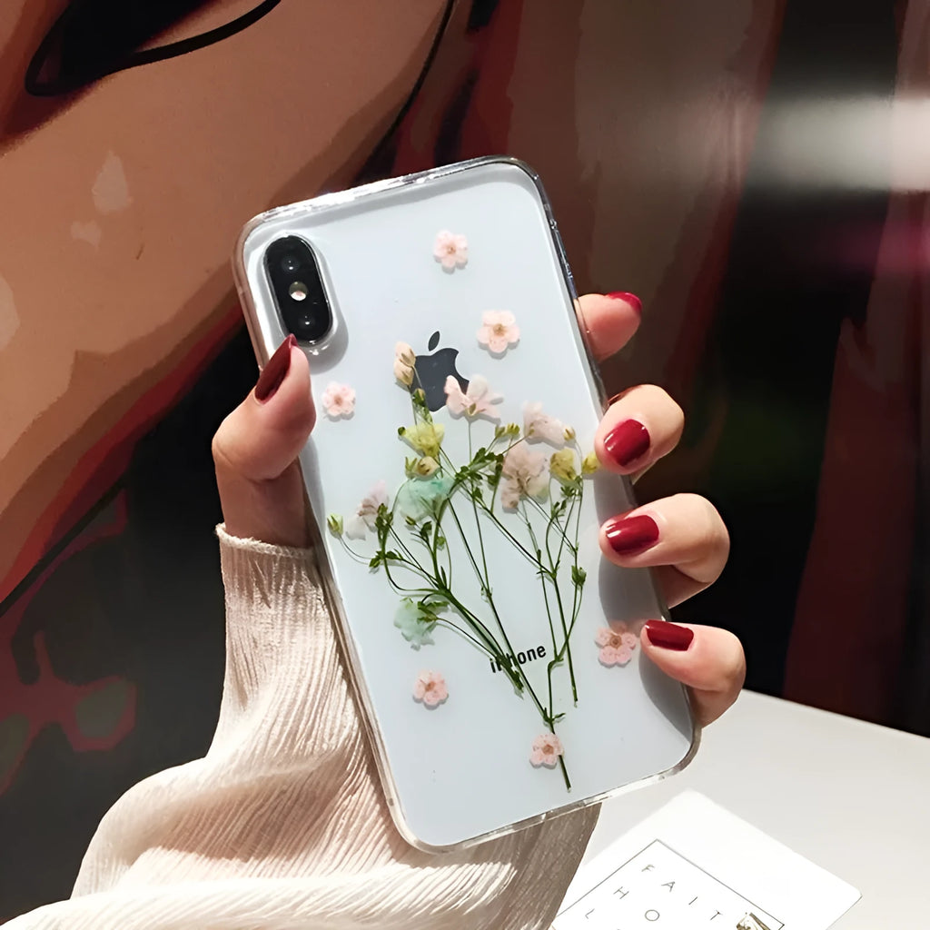Clear iPhone case with dried pink Qianliyao flowers preserved in epoxy resin on transparent TPU back