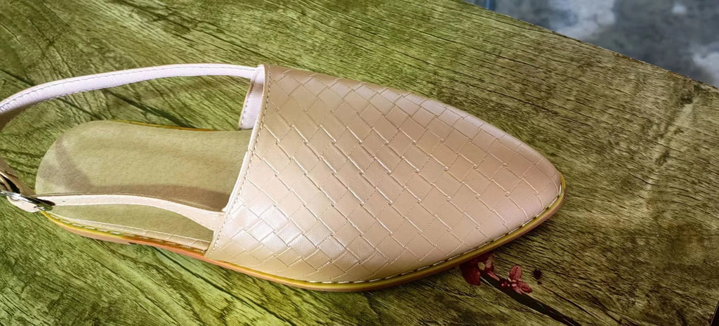 Women's black pointed toe flat sandals with a silver buckle fastening on the instep.