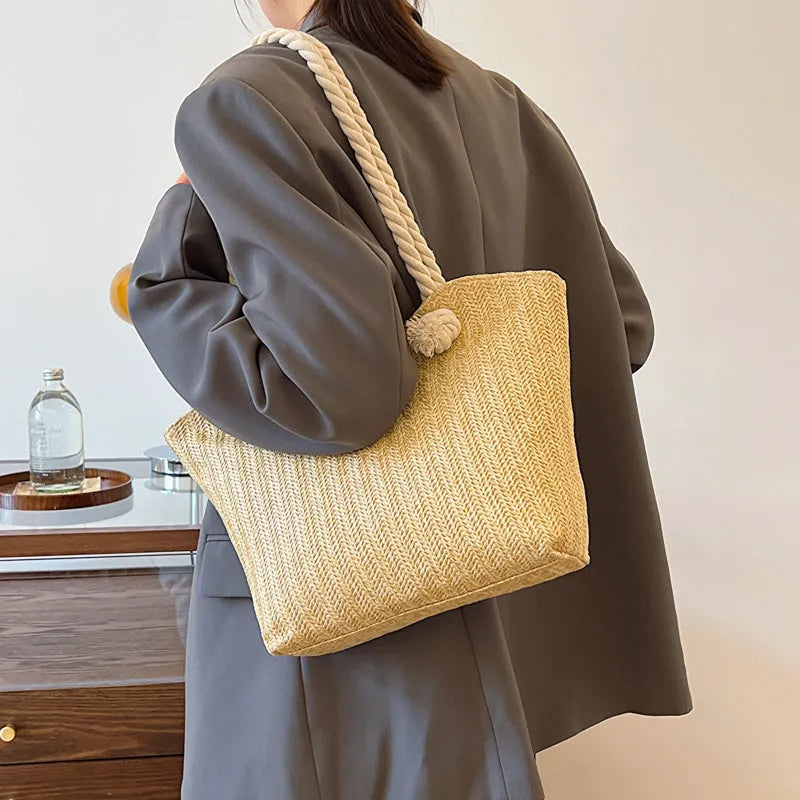 Women's straw shoulder handbag in white or khaki with clamshell opening, single strap, and phone bag