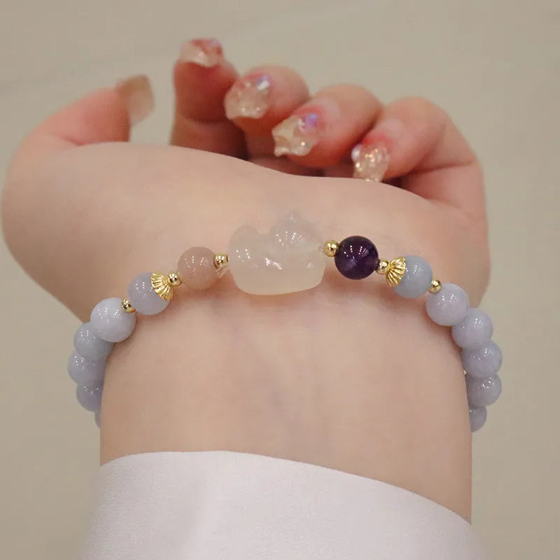 Women's gold-plated bracelet with artificial crystal and chalcedony pendant in climbing cat design