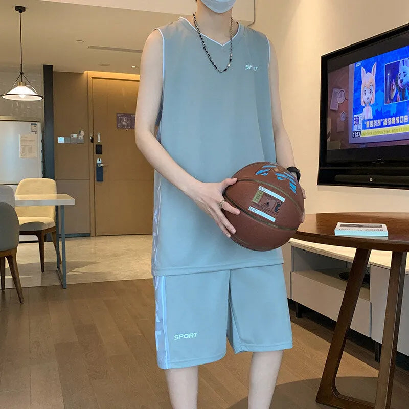 Light grey polyester basketball vest and shorts sports suit laid flat