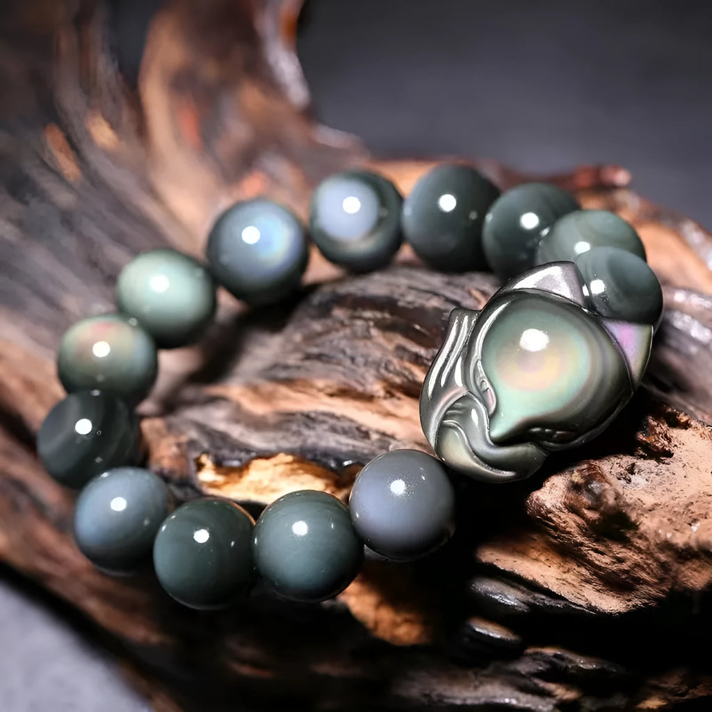 Obsidian fox carved bracelet in cartoon animal style showing detailed carving on black stone surface