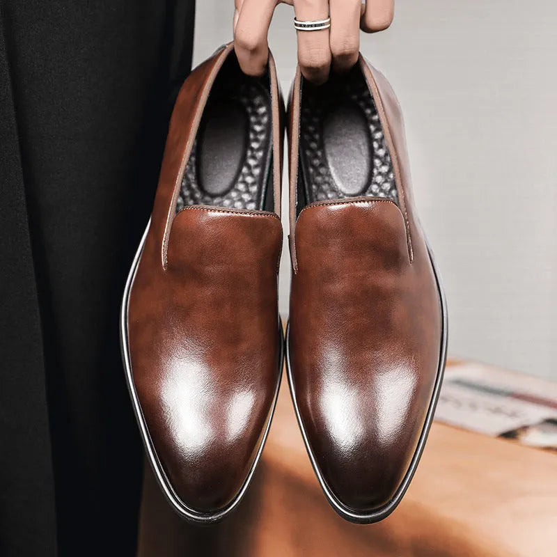 Men's polished pointed black leather shoes with leather toe cap and rubber sole, side view
