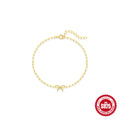 Close-up of a women's sterling silver bracelet with a glossy gold heart charm and lobster clasp.