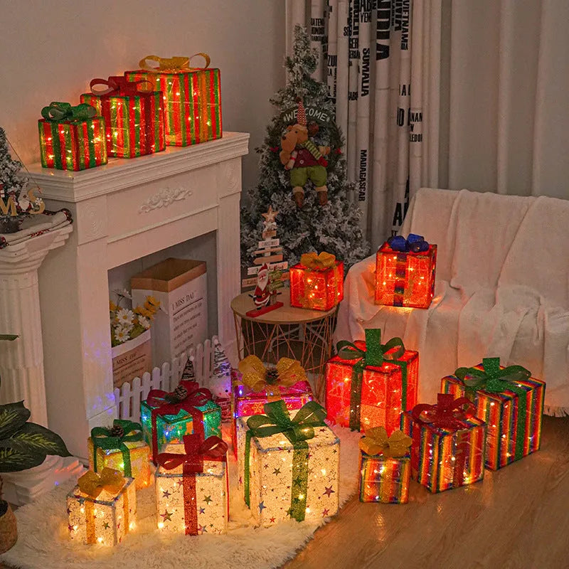 Set of three lighted Christmas gift box decorations with bows for outdoor holiday decor