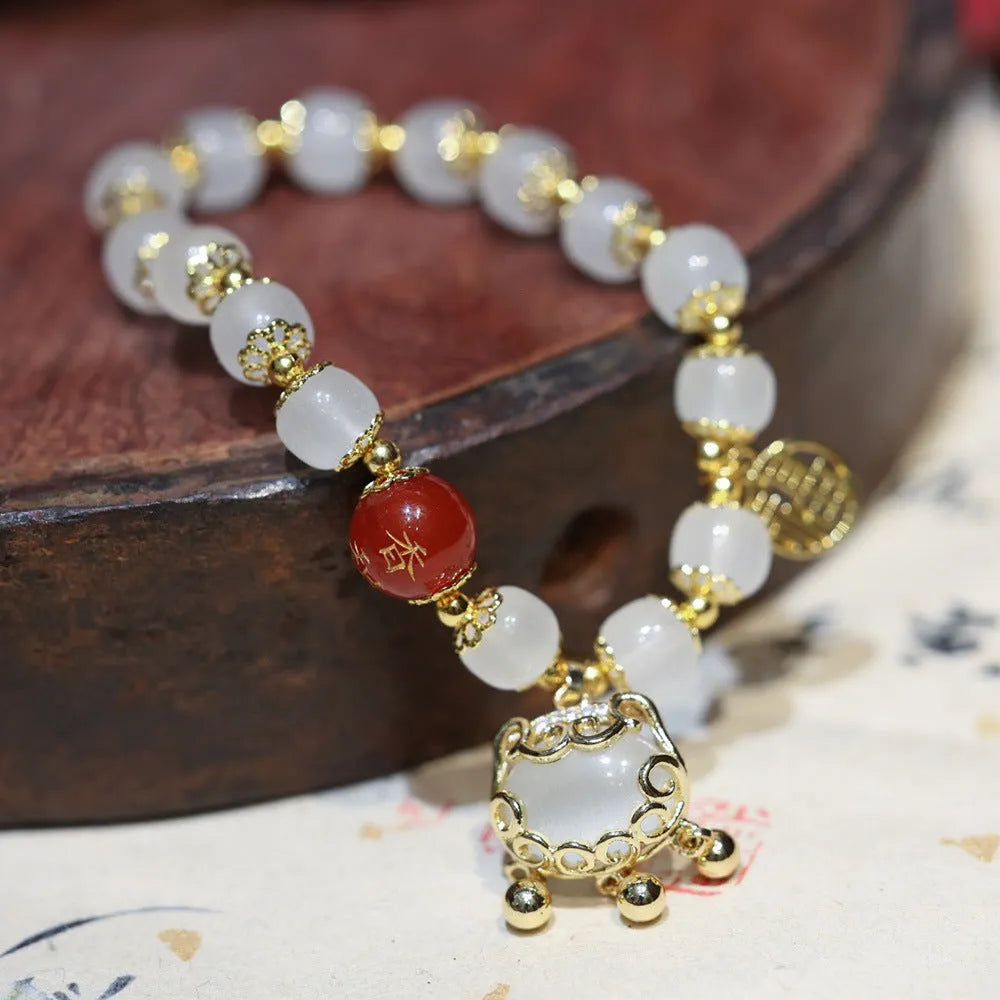 Chinese-style glass bracelet with coloured glaze, fu character, safety lock, windmill and bamboo presages charm designs