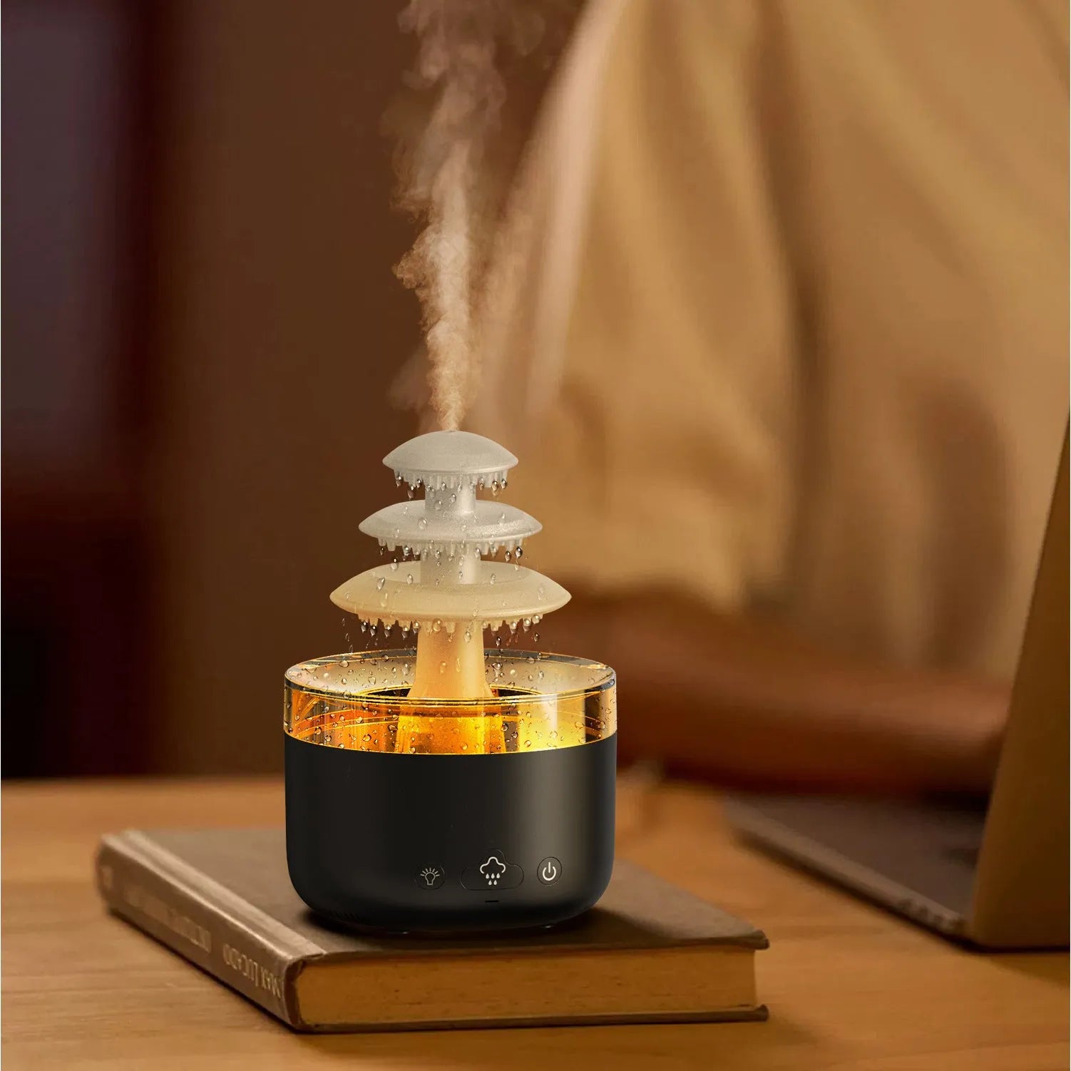 White Cloud Rain air humidifier and essential oil diffuser with colourful LED light on a table.