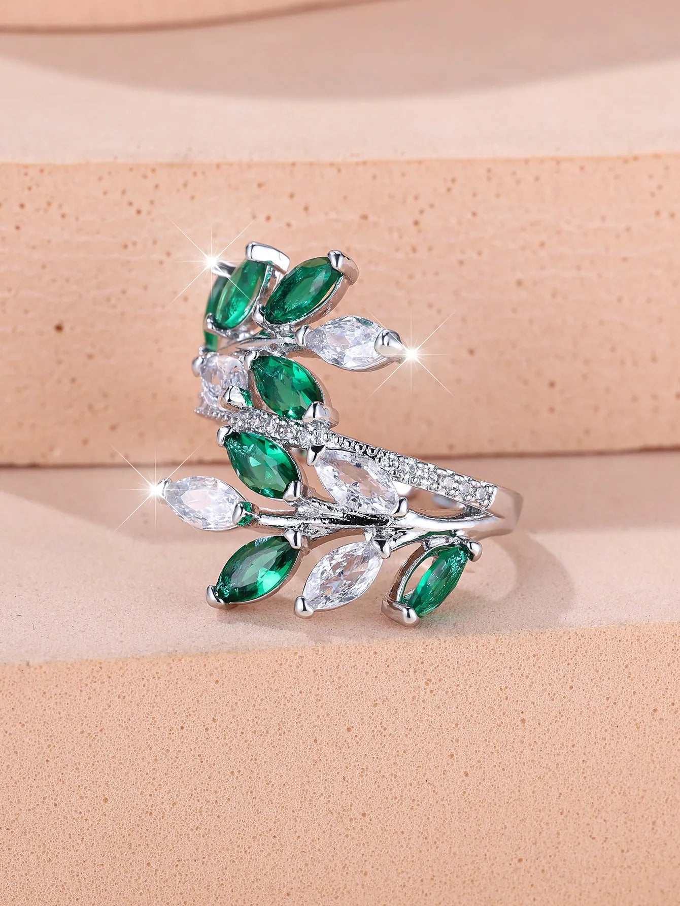 Adjustable copper leaf-shaped ring with a central horse eye zircon stone, shown in a rose gold finish.